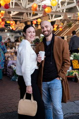 Couple smiling at camera at a flea market