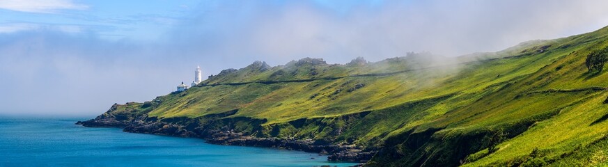 Naklejka premium Sea Fret over Cliffs, Start Point Lighthouse, Trinity House and South West Coast Path, Devon, England