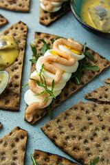 Swedish style crisp bread open sandwich with egg, arugula and cod roe paste topping.