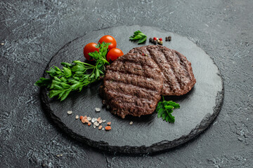 Grilled beefsteaks cutlets patties on a dark background, banner, menu, recipe place for text, top view
