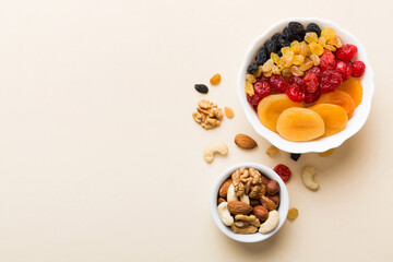 healthy snack: mixed nuts and dried fruits in bowl on table background, almond, pineapple, cranberry, cherry, apricot, cashew