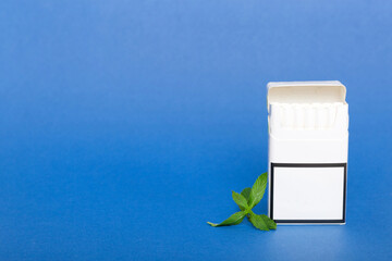 Pack of menthol cigarettes and fresh mint on colored table, Menthol cigarettes top view flat lay