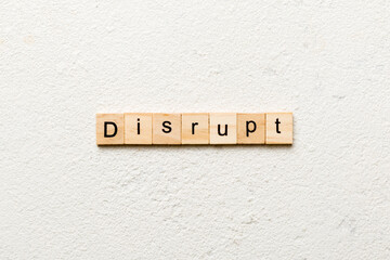 DISRUPT word written on wood block. DISRUPT text on cement table for your desing, concept