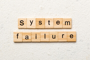system failure word written on wood block. system failure text on table, concept