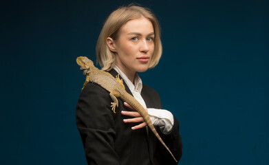portrait of a girl with a reptile.close-up of a girl with a lizard dragon agama isolated.