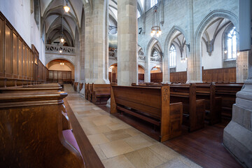 Reformed European church interior with empty wooden pews. Ultra wide angle view, no people