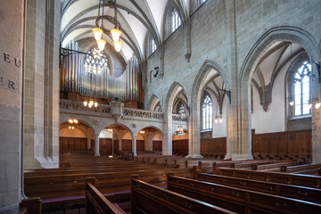Reformed European church interior with empty wooden pews. Ultra wide angle view, no people