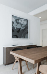 Interior with a large table. Dining area in the interior. Large frame on the wall and chest of drawers. 3D visualization