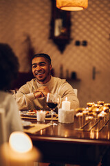 Smiling african american man having a romantic date with his girlfriend at home