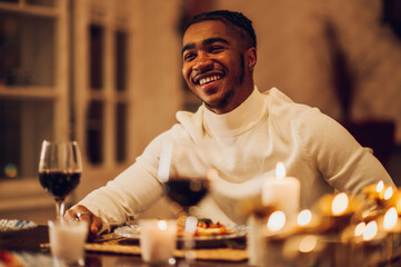 Smiling african american man having a romantic date with his girlfriend at home
