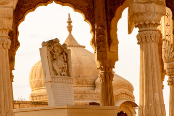 The royal cenotaphs of historic rulers, also known as Jaisalmer Chhatris, at Bada Bagh in Jaisalmer, Rajasthan, India. Cenotaphs made of yellow sandstone - obrazy, fototapety, plakaty