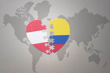 puzzle heart with the national flag of colombia and austria on a world map background.Concept.