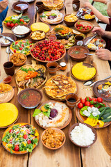 Homemade Romanian Food with grilled meat, polenta and vegetables Platter on camping. Romantic traditional moldavian food outside on the wood table.