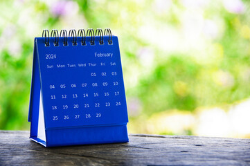 February 2024 blue table calendar with customizable space for text. Calendar concept and copy space.