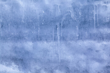 Texture of winter ice on a stone cliff. Blue natural ice background
