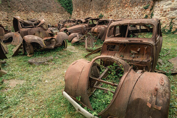 Old rusty cars left behind in Oradour-sur-Gllane, France.