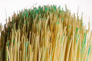 Close up macro photograph of a paintbrush with green on the bristles