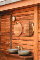 Two washbasins in a wooden outdoor bathroom
