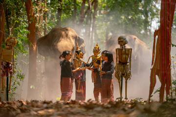 Group of Asian children show or practice manipulate the puppets in  front of big elephant in...