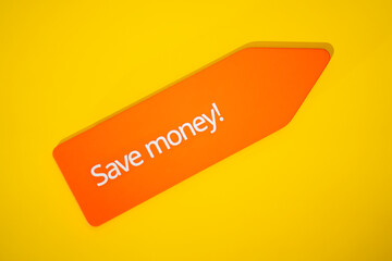 Save money! sign on orange arrow shaped tag isolated on yellow background. Discount, promotion and...