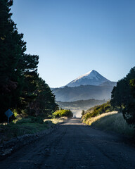 vehicle on road in argentine patagonia with lanin volcano in background