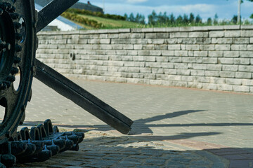 Fototapeta premium MOGILEV, BELARUS MAY 21 2023 Old tank. Wheels and track closeup and peaceful background Monument to old weapons close-up Symbol of end of war. Old military weapons Equipment of countrys armed forces.