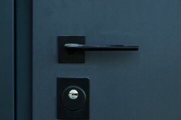 grey handle on a closed iron door. closed opportunities concept