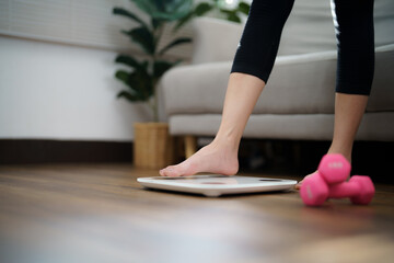 Fat diet and scale feet standing on electronic scales for weight control. Measurement instrument in kilogram for a diet control