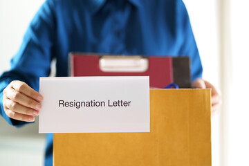 Quit Job Business man sending resignation letter and packing Stuff Resign Depress or carrying business cardboard box in office. Change of job or fired from company.