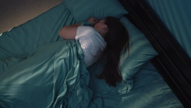 Nightmare, woman woke up and screamed in horror, scaredly looking with big eyes. Concept of insomnia.