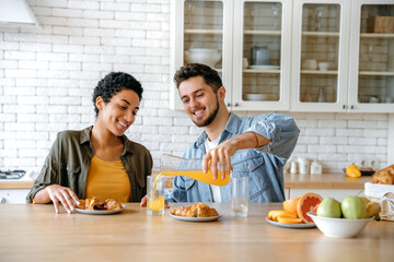 Happy multiracial couple, caucasian man and african american woman, spend time together at weekend...