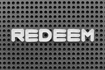 White alphabet letter in word redeem on black pegboard background