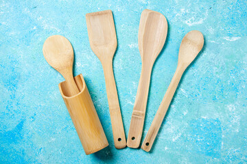top view various wooden spoons upright spoon rest on blue table
