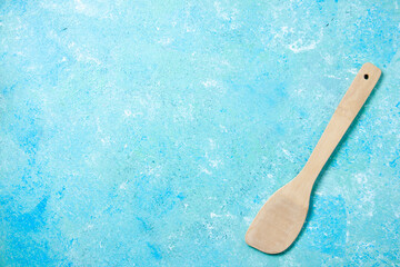 top view wooden spoon on blue background with free space