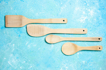 top view wooden spoons on blue background