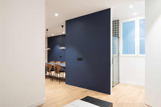 Interior of spacious apartment with blue wall