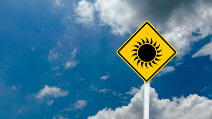 Yellow sign with painting of the sun with clouds and blue sky in background concept of bewaring of sun burns