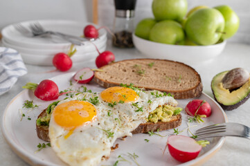 Fried egg sandwich with avocado spread