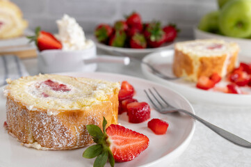 Slice of Swiss roll with strawberries and cream 