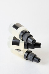 Set of plastic dropper bottles with liquid with black blank stickers. Mockup