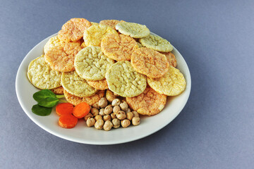 Chickpea chips snack with vegetables on gray background