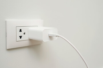 Close Up the electrical power socket and plug socket on wall.