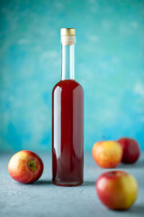 front view apple vinegar with apples on blue background juice fruit color photo red fresh drink...