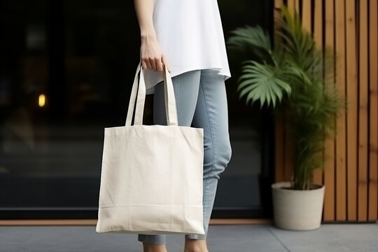 young girl is carrying a blank white cotton eco tote bag on wooden background. Mockup design, Generative AI