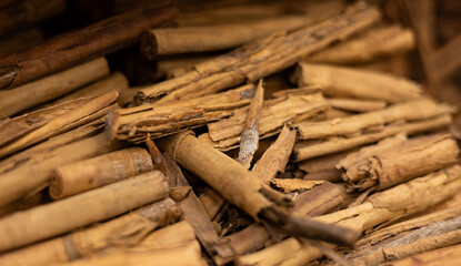 United Arab Emirates, Dubai, spice market, April 2023: Old souk bazaar market with herbs and spices. Close-up cinnamon sticks.