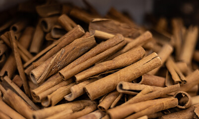 United Arab Emirates, Dubai, spice market, April 2023: Old souk bazaar market with herbs and spices. Close-up cinnamon sticks.