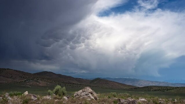 Timelapse of the clouds flowing the end of a rainstorm over Utah viewing mammatus clouds tailing the storm.
