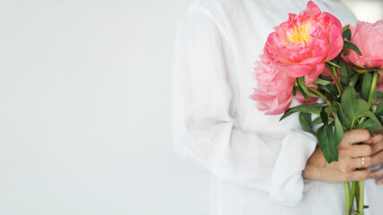 Woman holding a bouquet of peonies