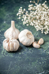 front view fresh garlics lined on gray background greens plant vegetable sour seasoning pepper