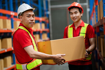 Two men working together to lift parcel boxes in a warehouse to deliver to customers. Freight and warehouse distribution. International export concept. logistic business. Warehousing industry.
